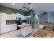 Modern kitchen with stainless steel appliances and wood island at 7951 E Posada Ave, Mesa, AZ 85212