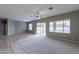 Spacious living room with tile floors, neutral walls, and a ceiling fan at 7951 E Posada Ave, Mesa, AZ 85212