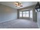 Spacious bedroom with bay window and ceiling fan at 7951 E Posada Ave, Mesa, AZ 85212