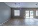 Living room with tile floors, neutral walls, and a sliding glass door at 7951 E Posada Ave, Mesa, AZ 85212