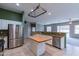 Stainless steel appliances and an island highlight this kitchen at 7951 E Posada Ave, Mesa, AZ 85212