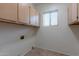 Laundry room with upper cabinets and tile flooring at 7951 E Posada Ave, Mesa, AZ 85212