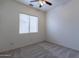 Well-lit bedroom featuring a ceiling fan and carpet at 7951 E Posada Ave, Mesa, AZ 85212