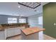Kitchen boasts granite countertops and a butcher block island at 7951 E Posada Ave, Mesa, AZ 85212