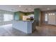Kitchen with breakfast bar and view into the dining area at 7951 E Posada Ave, Mesa, AZ 85212