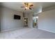 Primary bedroom with ceiling fan and access to bathroom at 7951 E Posada Ave, Mesa, AZ 85212