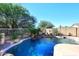 Relaxing backyard with a kidney-shaped pool and a tranquil waterfall feature at 4321 E Desert Sky Ct, Cave Creek, AZ 85331