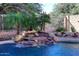 Stunning pool area with a natural rock waterfall feature at 4321 E Desert Sky Ct, Cave Creek, AZ 85331