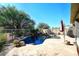 Inviting backyard oasis featuring a sparkling pool, waterfall, and spacious patio at 4321 E Desert Sky Ct, Cave Creek, AZ 85331