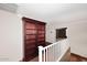 Loft area with built-in bookcase and wooden railing at 4321 E Desert Sky Ct, Cave Creek, AZ 85331