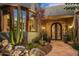 Stone pathway leads to the home's entryway with ornate double doors and desert plants at 40523 N 102Nd Pl, Scottsdale, AZ 85262