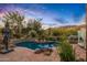 Freeform swimming pool with a mountain backdrop and lush landscaping at 40523 N 102Nd Pl, Scottsdale, AZ 85262