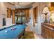 Game room with a pool table and wood-beamed ceiling at 40523 N 102Nd Pl, Scottsdale, AZ 85262