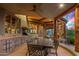 Covered patio with outdoor kitchen, dining area, and mountain views at 40523 N 102Nd Pl, Scottsdale, AZ 85262