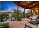 Spacious outdoor lounge with seating, a fireplace, and mountain views at 40523 N 102Nd Pl, Scottsdale, AZ 85262