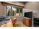 Home office with built-in desk, large window, and ample natural light at 40523 N 102Nd Pl, Scottsdale, AZ 85262