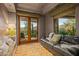 Cozy sitting area with a leather couch, large windows, and mountain views at 40523 N 102Nd Pl, Scottsdale, AZ 85262