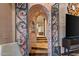 Unique hallway with an arched brick entryway and wrought iron gates at 40523 N 102Nd Pl, Scottsdale, AZ 85262