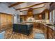 Open kitchen boasts a large island, dark stained custom cabinetry, and granite countertops at 40523 N 102Nd Pl, Scottsdale, AZ 85262