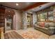 Stone and wood-accented sitting area with a couch and views to the backyard at 40523 N 102Nd Pl, Scottsdale, AZ 85262