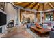 Living room with a fireplace and wood-beamed ceiling at 40523 N 102Nd Pl, Scottsdale, AZ 85262
