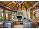 Living room with a stone fireplace and wood beams at 40523 N 102Nd Pl, Scottsdale, AZ 85262