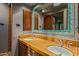 Double vanity bathroom with terracotta tile and large mirror at 40523 N 102Nd Pl, Scottsdale, AZ 85262