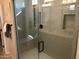 Large walk-in shower with a built-in bench seat at 9963 W Cora Ln, Avondale, AZ 85392