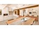 Open concept dining room with kitchen views and a fireplace at 10044 E Graythorn Dr, Scottsdale, AZ 85262