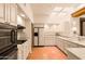 Modern kitchen with white cabinets, stainless steel appliances, and tile floors at 10044 E Graythorn Dr, Scottsdale, AZ 85262
