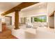 Spacious living room with hardwood floors, a fireplace, and large windows at 10044 E Graythorn Dr, Scottsdale, AZ 85262