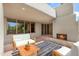 Outdoor patio with fireplace and seating area at 10044 E Graythorn Dr, Scottsdale, AZ 85262
