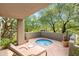 Relaxing patio with spa, lounge chair, and desert landscaping at 10044 E Graythorn Dr, Scottsdale, AZ 85262