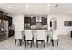 Modern kitchen with dark wood cabinets and a large island at 19696 N 271St Ave, Buckeye, AZ 85396