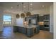 Modern kitchen with large island, stainless steel appliances, and custom cabinetry at 13272 E La Junta Rd, Scottsdale, AZ 85255
