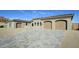 New construction home with beige facade and three-car garage at 13272 E La Junta Rd, Scottsdale, AZ 85255