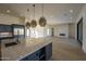 Modern kitchen with large island, stainless steel appliances, and custom cabinetry at 13272 E La Junta Rd, Scottsdale, AZ 85255
