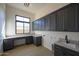 Bright laundry room with ample cabinetry and a utility sink at 13272 E La Junta Rd, Scottsdale, AZ 85255