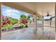 Covered patio with flagstone flooring and lush landscaping at 17828 W Mariposa Dr, Surprise, AZ 85374