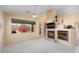 Living room featuring a fireplace and backyard access at 17828 W Mariposa Dr, Surprise, AZ 85374