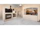 Bright living room with fireplace, and view into kitchen at 17828 W Mariposa Dr, Surprise, AZ 85374