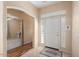 Bright entryway with tile flooring, wood-look flooring, and access to an office at 17828 W Mariposa Dr, Surprise, AZ 85374