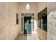 Covered entryway with teal door and glass block accents at 17828 W Mariposa Dr, Surprise, AZ 85374
