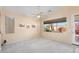 Living room with large window and ceiling fan at 17828 W Mariposa Dr, Surprise, AZ 85374