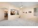 Spacious living room with kitchen view and ceiling fan at 17828 W Mariposa Dr, Surprise, AZ 85374