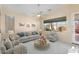 Living room with staged furniture, large window, and ceiling fan at 17828 W Mariposa Dr, Surprise, AZ 85374