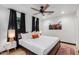 Bright bedroom featuring a king-size bed and modern ceiling fan at 3014 N 61St Pl, Scottsdale, AZ 85251