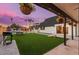 Large backyard with artificial turf, grill, and cornhole at 3014 N 61St Pl, Scottsdale, AZ 85251