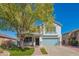 Two story house with teal garage door and manicured lawn at 17186 W Post Dr, Surprise, AZ 85388