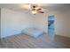 Bedroom with wood-look floors, walk-in closet, and ceiling fan at 17186 W Post Dr, Surprise, AZ 85388
